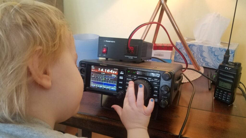 Child turning the VFO dial on a Yaesu FT-991A