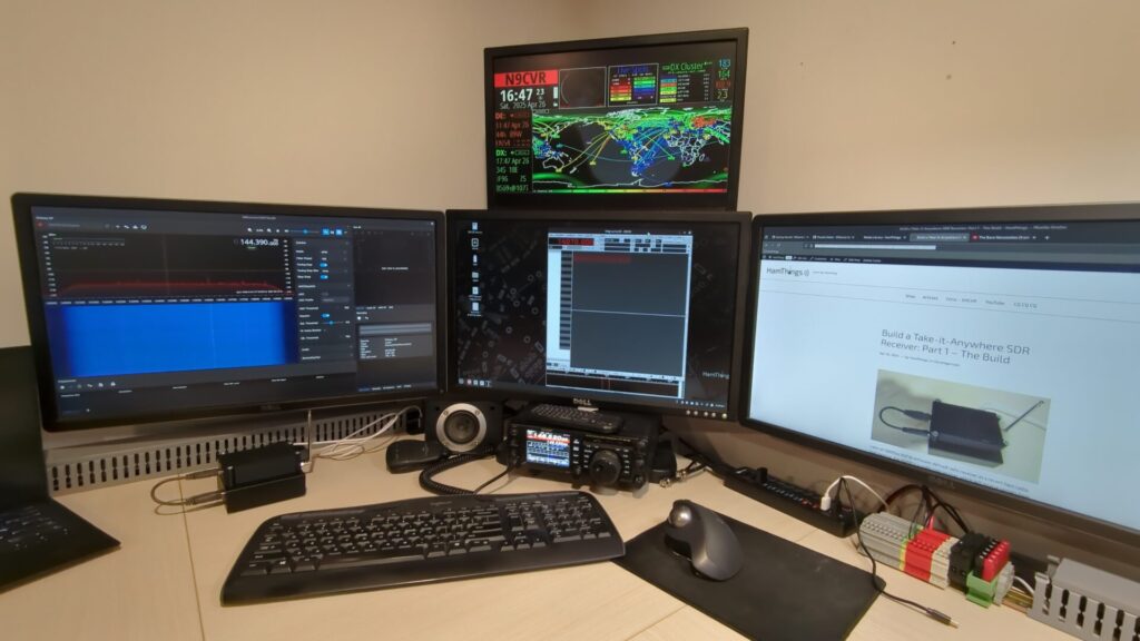 Chris' ham shack, with a HamClock as the top-center monitor