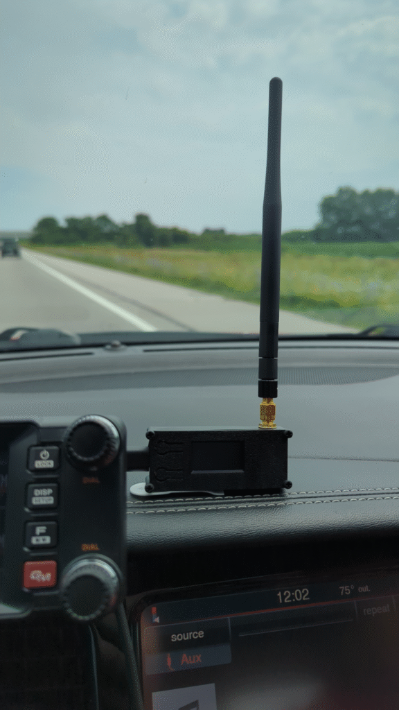 Small Heltec v3 Meshtastic node on the dashboard of a car